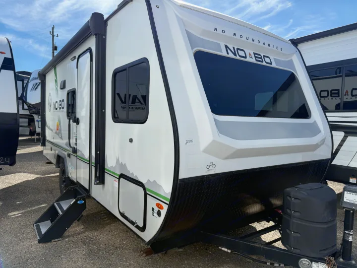 Experience outdoor adventure with this "No Boundaries" travel trailer RV rental, featuring a modern white and grey design.. No Boundaries 19 2022