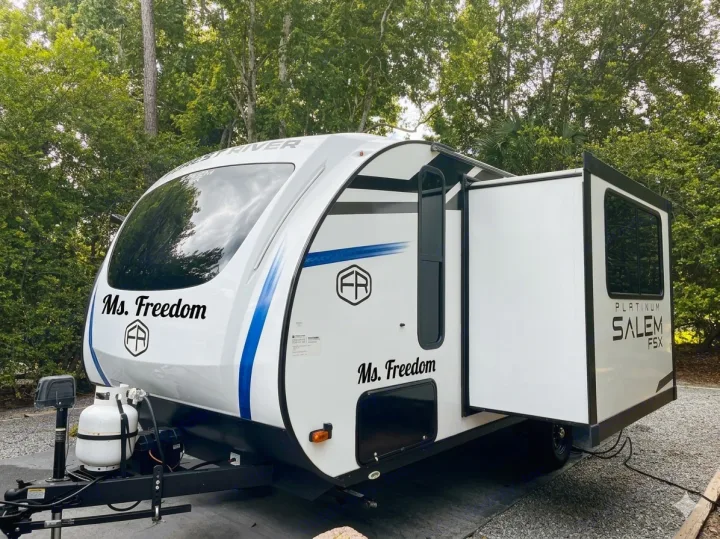 White Forest River Salem FSX travel trailer, "Ms. Freedom," with slide-out extended, perfect for your next rv rental adventure.. Forest River Salem FSX 2025
