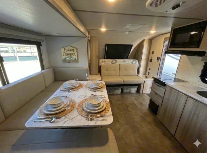 Step inside this modern RV rental: a bright interior with a set dinette, kitchen, and comfy seating.. Forest River Salem FSX 2025