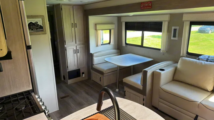 Light & modern RV rental interior: dinette, sofa, kitchen, and storage for a cozy travel or camping trip.. Coachman Catalina, Legacy edition 343BHTS 2024