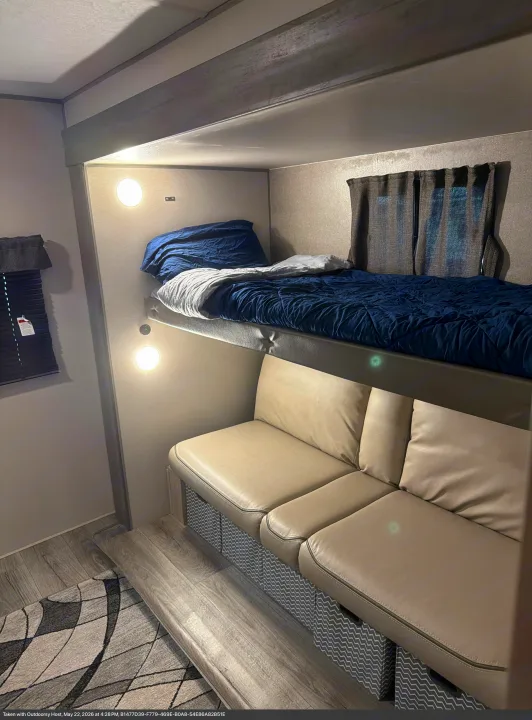Cozy rv rental interior featuring bunk beds with blue bedding and a comfy dinette seating area, ideal for travel and relaxation.. Coachman Catalina, Legacy edition 343BHTS 2024