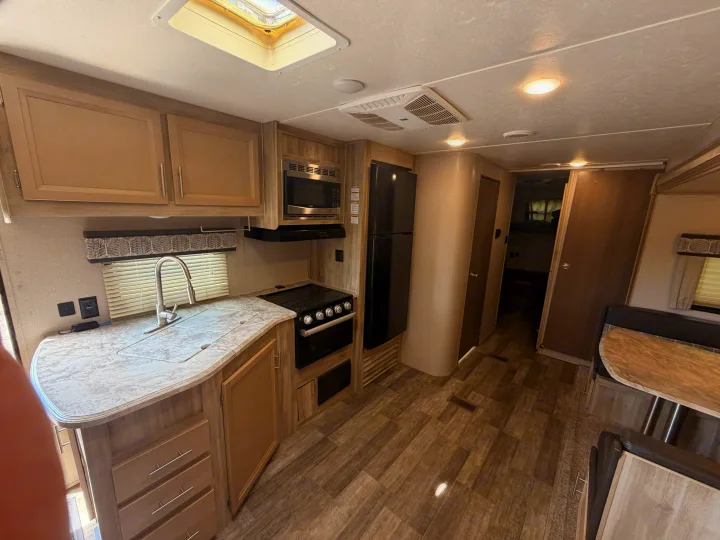 Discover this bright RV rental featuring a well-appointed kitchen with sink, stove, microwave, fridge, and cozy dining booth.. Coachmen Other 2021