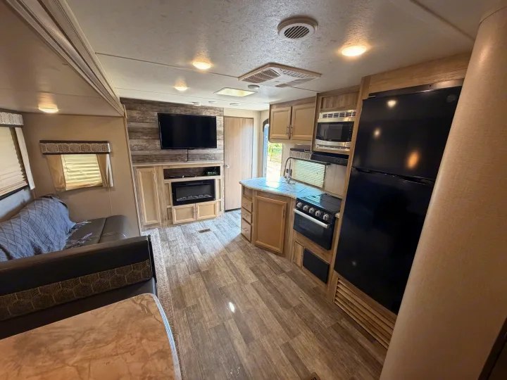 Spacious and modern RV rental interior featuring a full kitchen, living area with TV & fireplace, and comfortable seating.. Coachmen Other 2021
