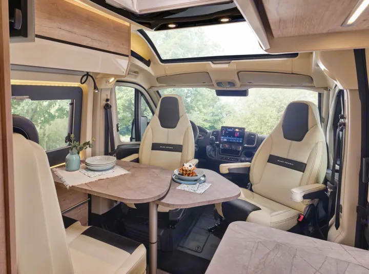 Experience comfort in this RV rental's modern interior: swiveling front seats, dining area, and bright skylight.. FLORIUM BLACK PEARL 63 LJ 2025