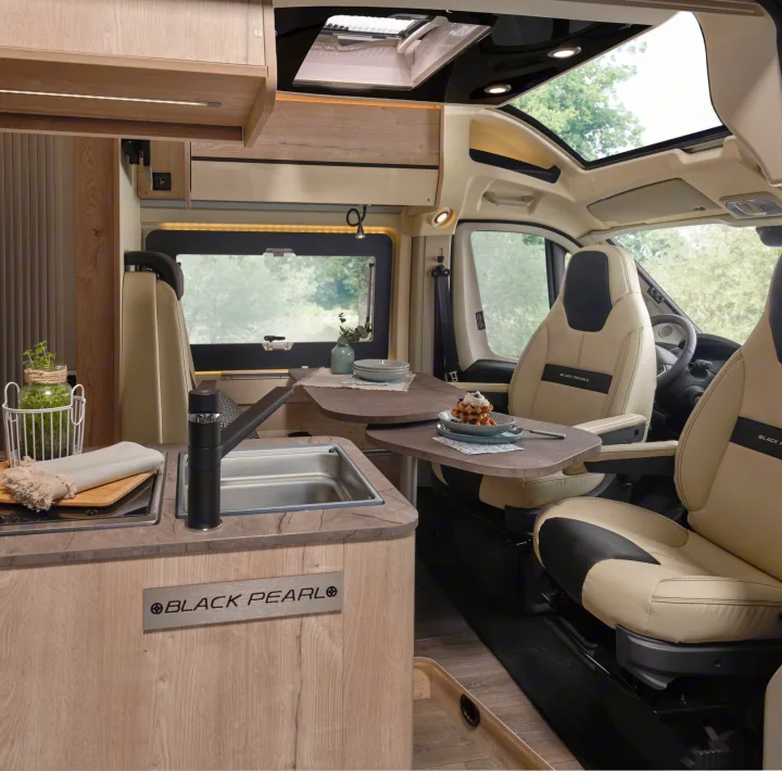 Modern Black Pearl rv rental interior: kitchen, dining area, and swivel seats for your next adventure.. FLORIUM BLACK PEARL 63 LJ 2025