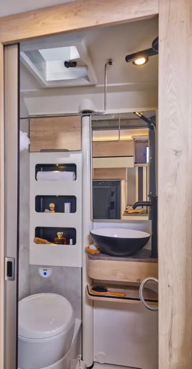 Experience comfort in a compact RV rental bathroom: toilet, modern sink, shower, and clever storage solutions.. FLORIUM BLACK PEARL 63 LJ 2025