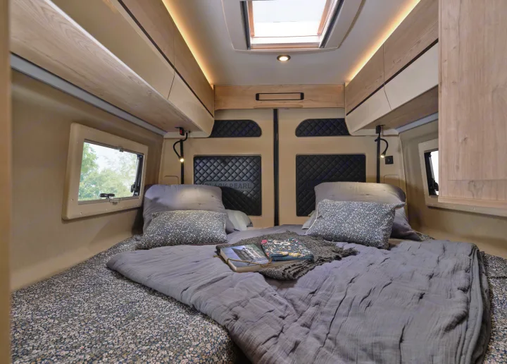 Cozy RV rental bedroom with floral bedding, skylight, and comfy pillows, perfect for a relaxing road trip.. FLORIUM BLACK PEARL 63 LJ 2025