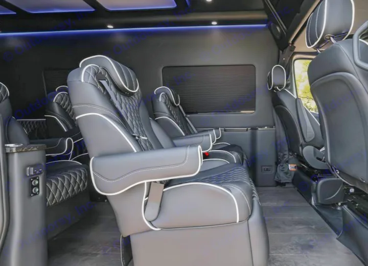 Luxurious black leather captain's chairs inside an RV rental, featuring white piping and ambient lighting for a comfortable journey.. Mercedes Benz by Legends Sprinter 3500xd 170 Ext AWD Executive Lounger 2023