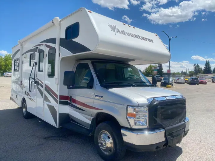 A bright white and silver Adventurer RV rental, a Class C motorhome, is parked on a sunny day, ready for adventure.. Adventurer Adventurer Motorhome 2016