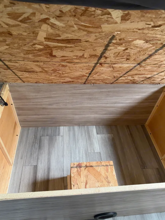 RV rental storage compartment with OSB lid and wood-look laminate floor. Organize your items for the road.. Minnie Minnie Trailer 2022