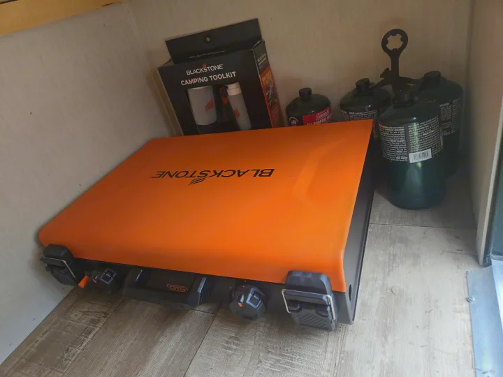 Organized RV rental storage: Blackstone griddle, toolkit, and Coleman propane tanks for camping adventures.. Forest River Cherokee Wolf Pup 2022