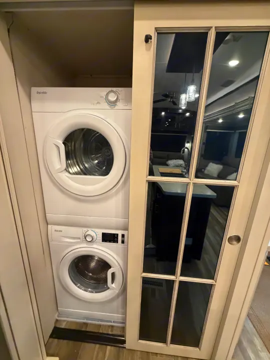 Splendide compact washer/dryer in an RV rental, offering laundry convenience on the go. Mirrored door reflects living area.. Jayco North Point 2021