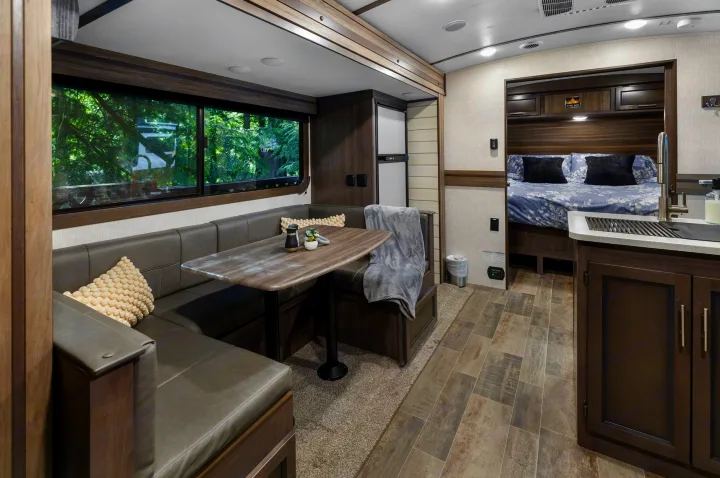 Cozy RV rental interior with dinette, kitchen, and bedroom view. Perfect for travel adventures.. Crossroads RV Sunset Trail Super Lite 2022