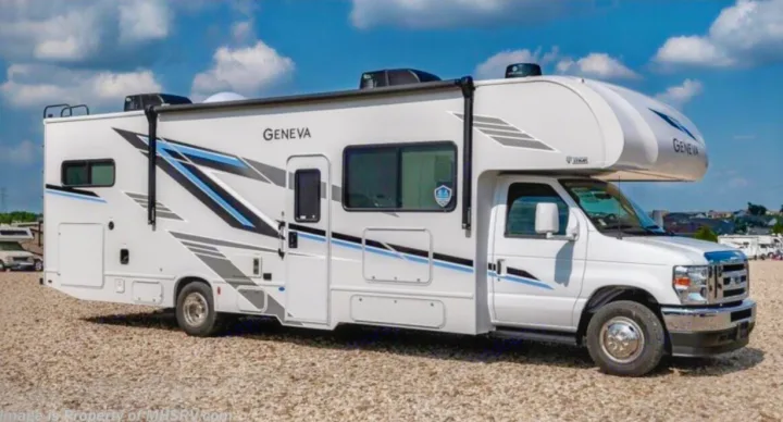 White Class C Geneva motorhome for rv rental, featuring blue and grey graphics, parked on a gravel lot under a blue sky.. Thor Geneva 2025