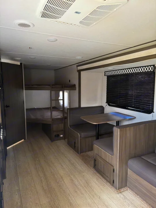 This rv rental offers comfy bunk beds, a dinette, and AC. Perfect for family trips with durable wood-look flooring.. Forest River Shasta 2021