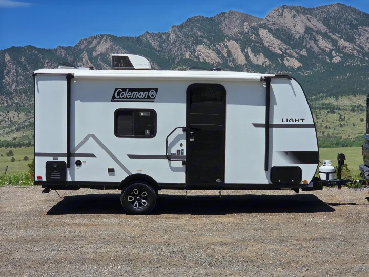 White Coleman travel trailer, an ideal RV rental for mountain adventures & camping trips.. coleman 17rx 2026