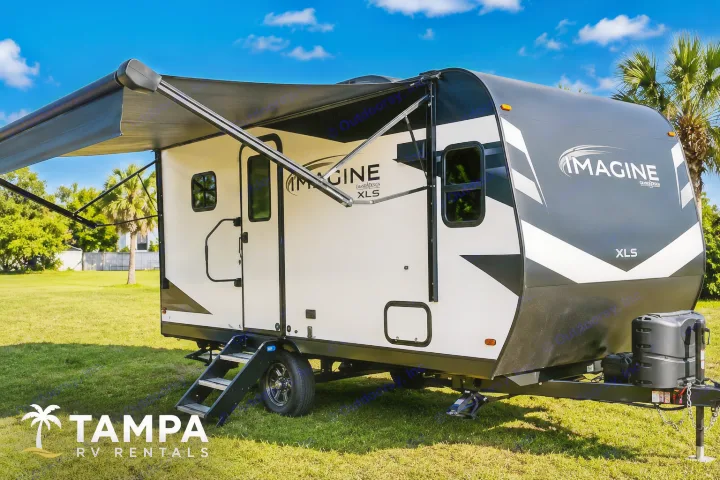 Imagine XLS travel trailer rv rental, parked with awning extended. Ideal for your next outdoor camping adventure.. Grand Design Imagine AIM 2023