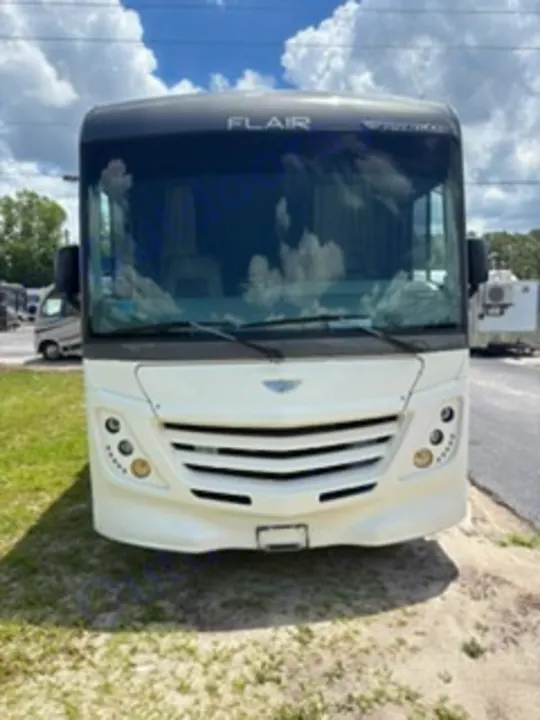 Front view of a white Fleetwood Flair Class A motorhome parked on grass, available for rv rental adventures.. Fleetwood FLAIR 2020