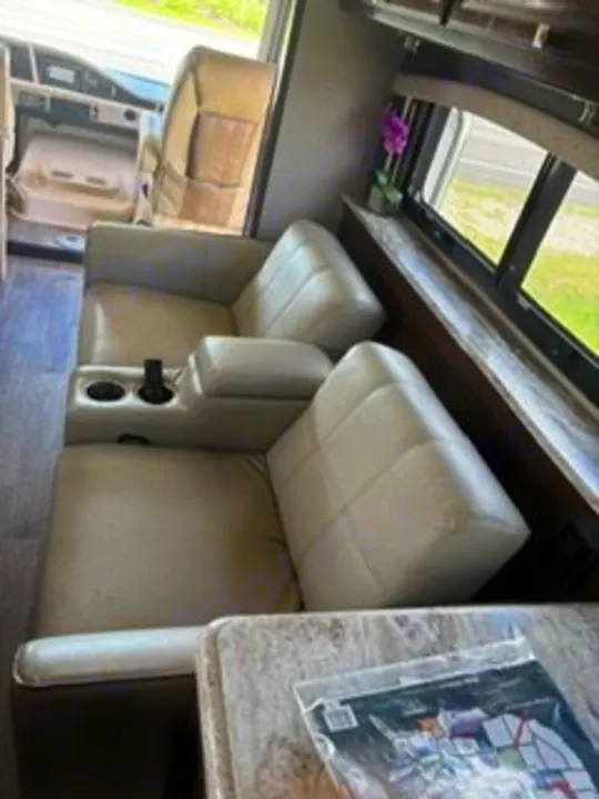 Inside an RV rental: two comfy recliners with cup holders, offering a relaxing seating area for your journey.. Fleetwood FLAIR 2020