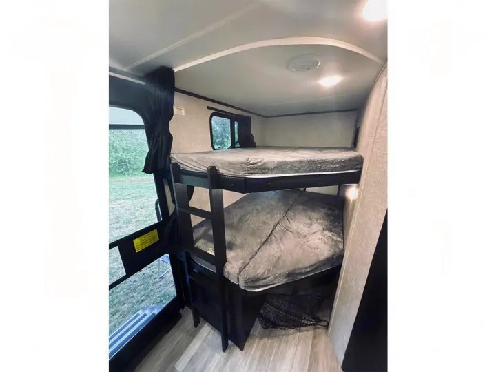 RV rental with comfy bunk beds, ideal for maximizing sleeping space in a compact camper interior for travelers.. Jayco Jay Feather 2022