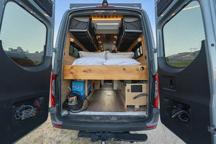 Inside this **rv rental** camper van: an elevated bed, under-bed storage with a power inverter, and coiled gear.. MERCEDES-BENZ SPRINTER 2500 170 WB 2022
