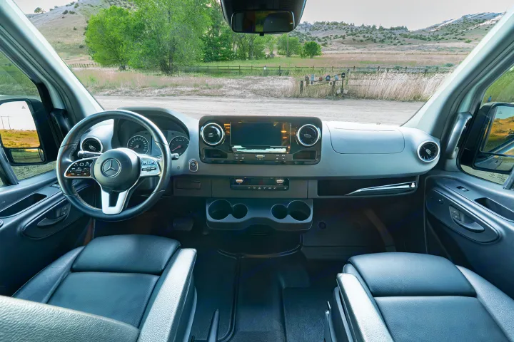 RV rental interior showcasing a modern Mercedes-Benz dashboard, steering wheel, and comfortable front seats, ready for adventure.. MERCEDES-BENZ SPRINTER 2500 170 WB 2022