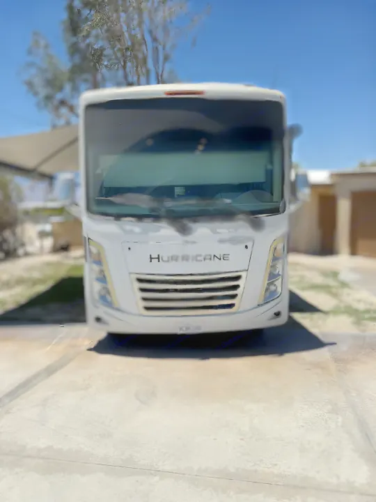 Front view of a white Hurricane RV rental parked on a sunny driveway, ready for your next road trip adventure.. Thor Hurricane 2024