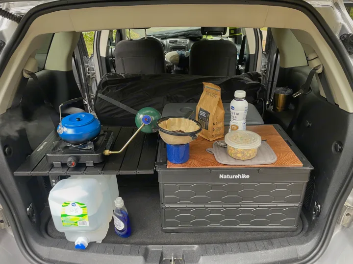 RV rental experience: SUV trunk transformed into a portable kitchen with stove, coffee, and water for car camping.. Dodge Journey 2016