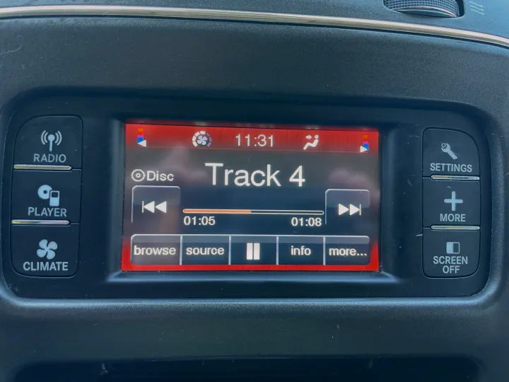 RV rental infotainment: screen shows 'Track 4' playing from disc (01:05 mark). Audio, radio, and climate controls at 11:31.. Dodge Journey 2016