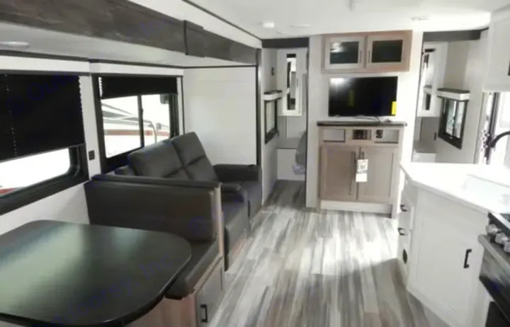 Modern rv rental interior showing a living space with a sofa, dinette, kitchen, and entertainment center. Clean and bright.. Jayco Jay Flight 2024