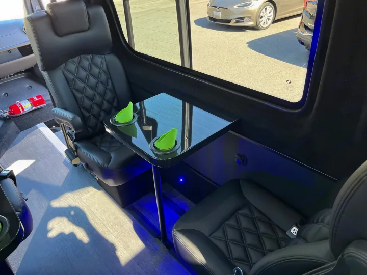 Experience premium comfort in our RV rental! Featuring executive seating, a functional table, and ambient lighting for luxurious travel.. Forest River 2025
