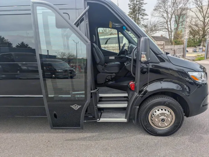 Black L.A. West Sprinter van with open side door, showing steps & driver's seat. Consider for your rv rental.. Forest River 2025