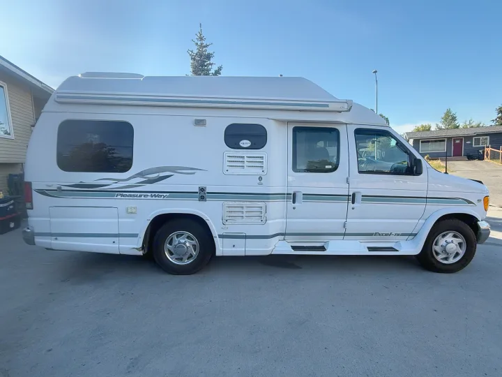 White Pleasure-Way Excel-TS camper van parked outside on a sunny day. This RV is ideal for your next rv rental adventure.. Pleasure-Way Pleasure-Way Class B 2002