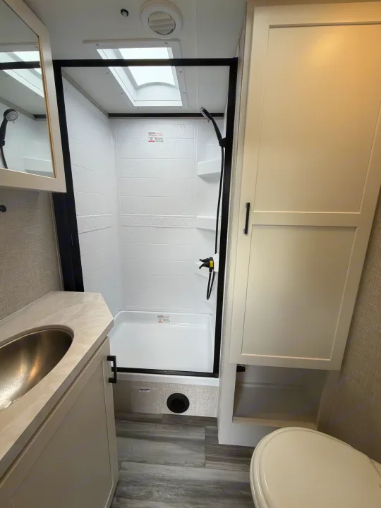 RV rental bathroom featuring a modern shower, sink, and toilet, maximizing space for travelers.. Jayco Eagle HT 2025