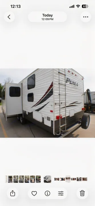 Puma travel trailer RV rental exterior, showing the rear with a slide-out, ladder, and spare tire.. Palomino Puma 2015