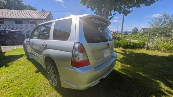 Silver 'Gwan Adventures' SUV in scenic BC. Picture your next journey, perhaps an RV rental, exploring views like these!. Subaru Forester 2009