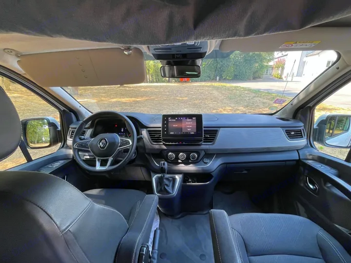 Interior view of an RV rental: modern dashboard, steering wheel, and front seats of a camper van, driver's perspective.. HANROAD TREK 5 2026