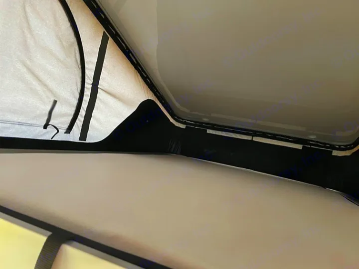 RV rental pop-top interior: Light fabric tent walls and black framing of the raised camper roof, providing extra head space.. HANROAD TREK 5 2026