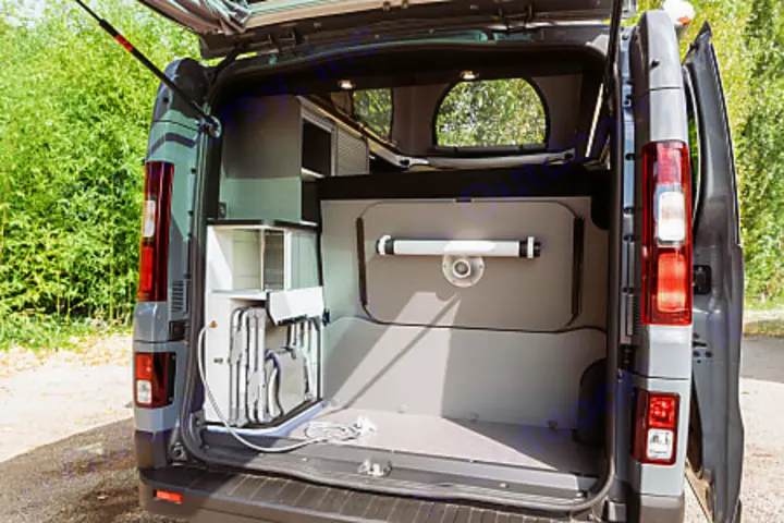 RV rental: Open rear of camper van showcasing a modular kitchen unit, folded equipment, and pop-top camper roof.. HANROAD TREK 5 2026