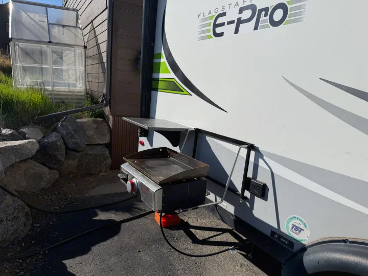 RV rental: Flagstaff E-Pro camper trailer with an outdoor griddle setup, ideal for convenient outdoor cooking.. Forest River Flagstaff E-Pro 2022