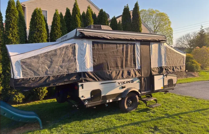 Explore the outdoors with this deployed Viking pop-up trailer, a great RV rental option for camping.. Forest River Viking LS 2022