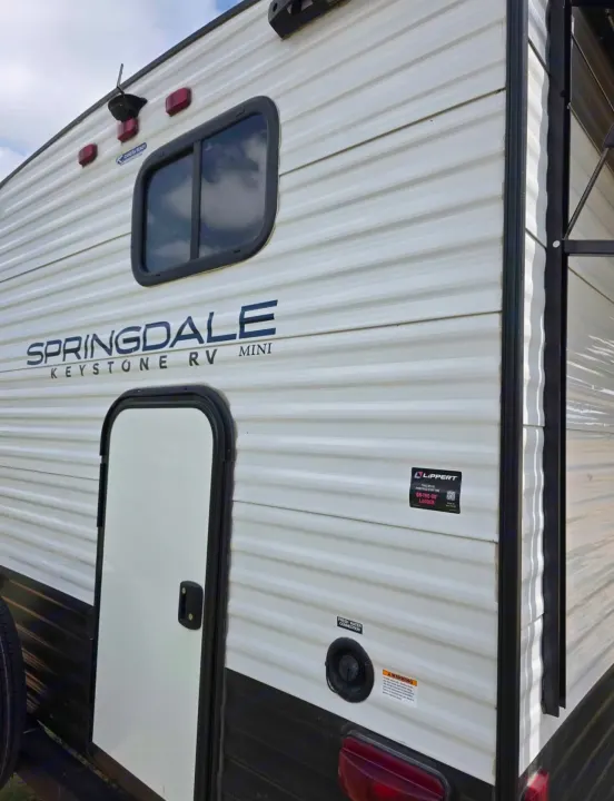 Springdale Keystone Mini RV exterior, ready for an RV rental adventure with fresh water & camera prep.. Keystone RV Springdale 2023