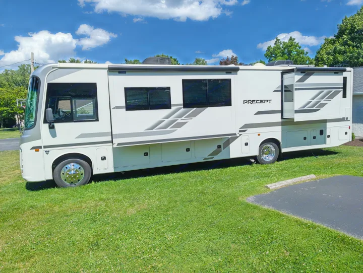 This white and grey Precept motorhome, with slide-outs extended, is ready for your next RV rental adventure.. Jayco Precept 2025