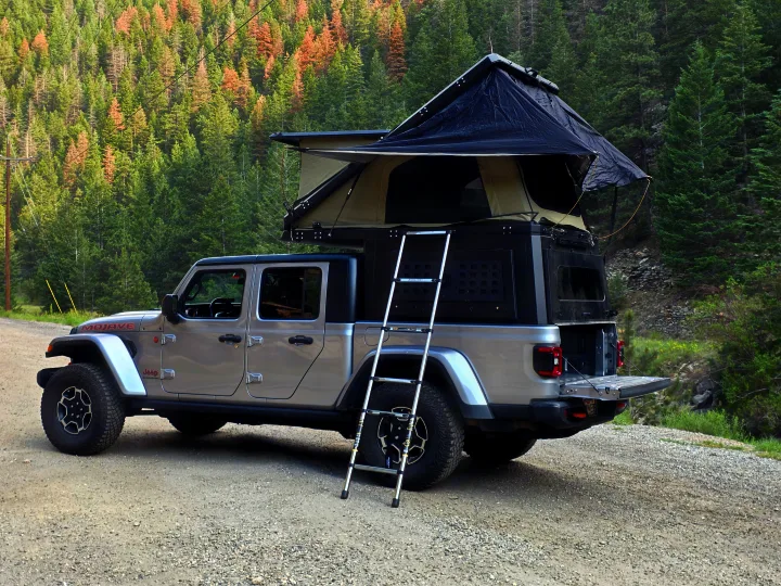 This rugged Jeep Gladiator, equipped with an overland camper & open rooftop tent, is perfect for an off-road rv rental adventure.. jeep Gladiator 2021