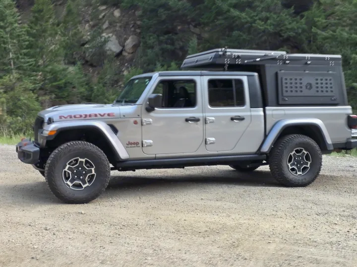 Explore off-road with this silver Jeep Gladiator Mojave. Equipped with an overlanding setup, it's an ideal adventure RV rental.. jeep Gladiator 2021