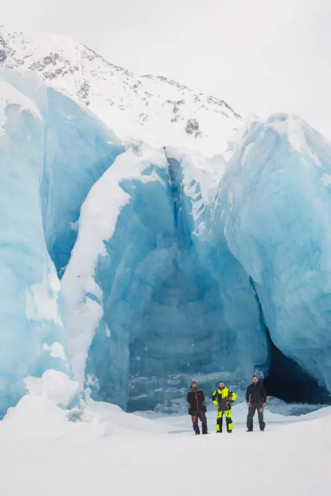 An RV rental trip leads to a magnificent blue glacier ice cave, explored by three men amidst snow-covered mountains.. Ford Econolline 250s 1998
