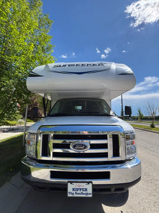 Front view of a white Ford Sunseeker RV rental under a blue sky. Perfect for your next motorhome road trip.. Forest River Sunseeker LE 2020