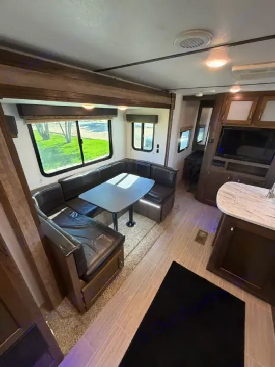 Explore this RV rental's comfortable interior, boasting a U-shaped dinette, kitchen area, and entertainment system.. Keystone RV Passport Ultra Lite 2019