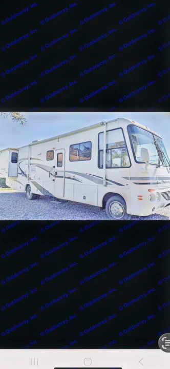 A white Challenger Class A RV rental, with extended slide-outs, is parked on gravel, ready for your next travel adventure.. Ford 1F6NF3S740A06630 2004