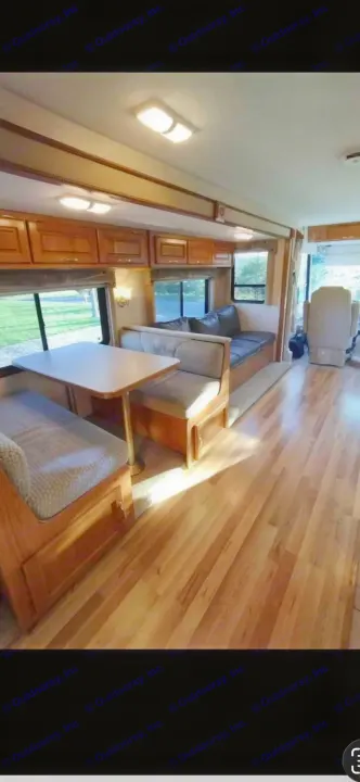 Spacious RV rental interior with dinette, comfy lounge, and warm wood finishes. Enjoy your home on wheels!. Ford 1F6NF3S740A06630 2004